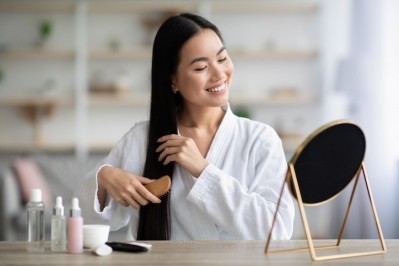 A woman combing her hair. ©Getty Images 