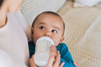 A mother feeding her baby milk. ©Getty Images 