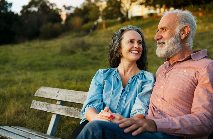 A senior couple sitting on the bench. ©Getty Images 